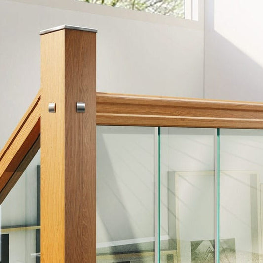 Stairs glass panels - landing closeup with oak