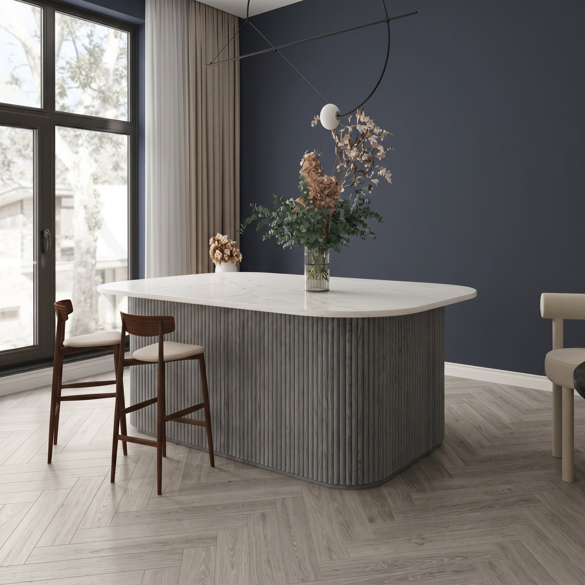Grey flexible fluted reeded acoustic tambour panel wrapped around a curved island counter, navy wall