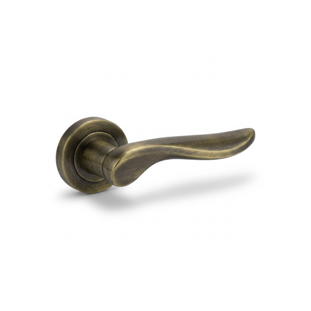 Venice antique brass curved lever door handle on round rose
