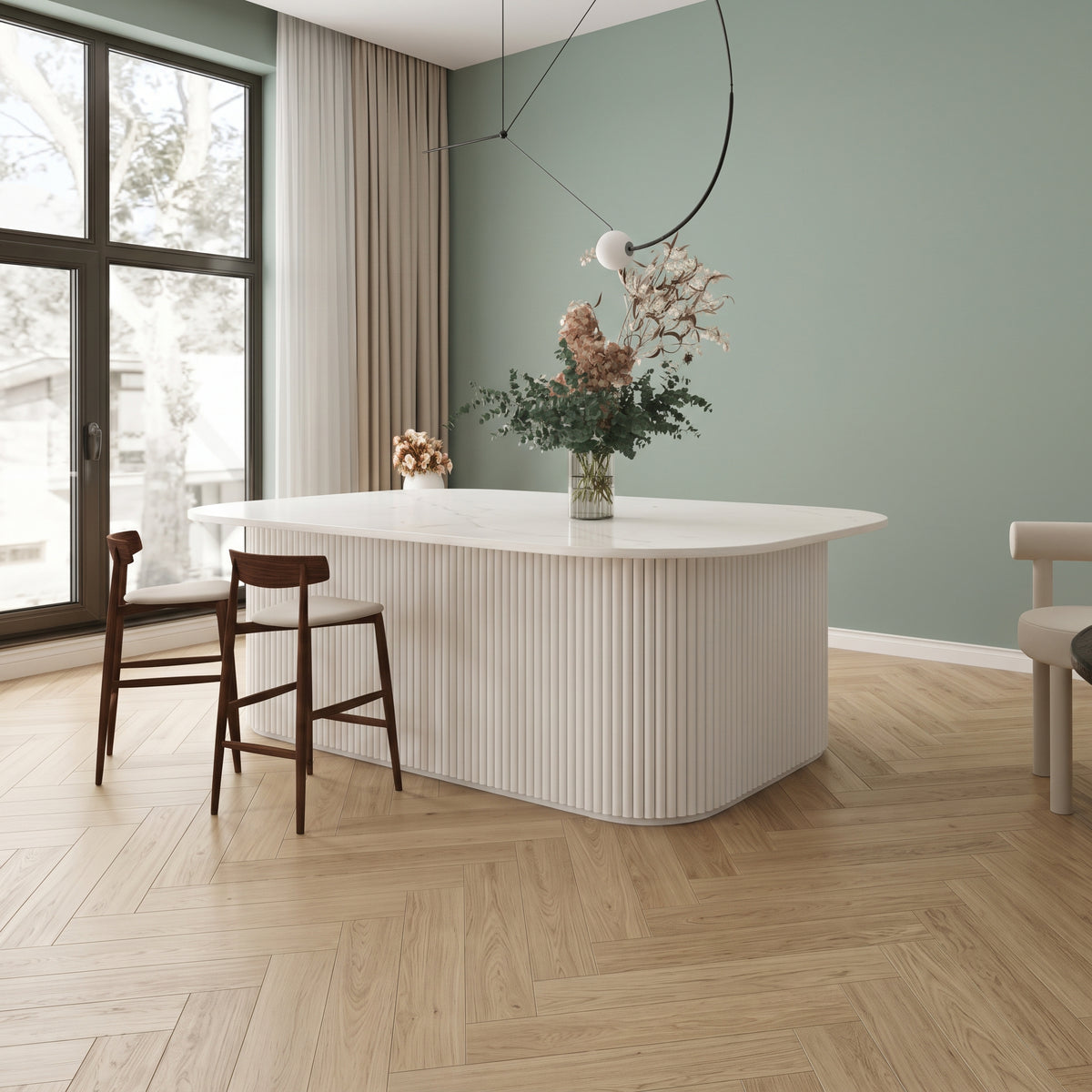 White flexible fluted reeded acoustic tambour panel wrapped around a curved island counter, sage green wall